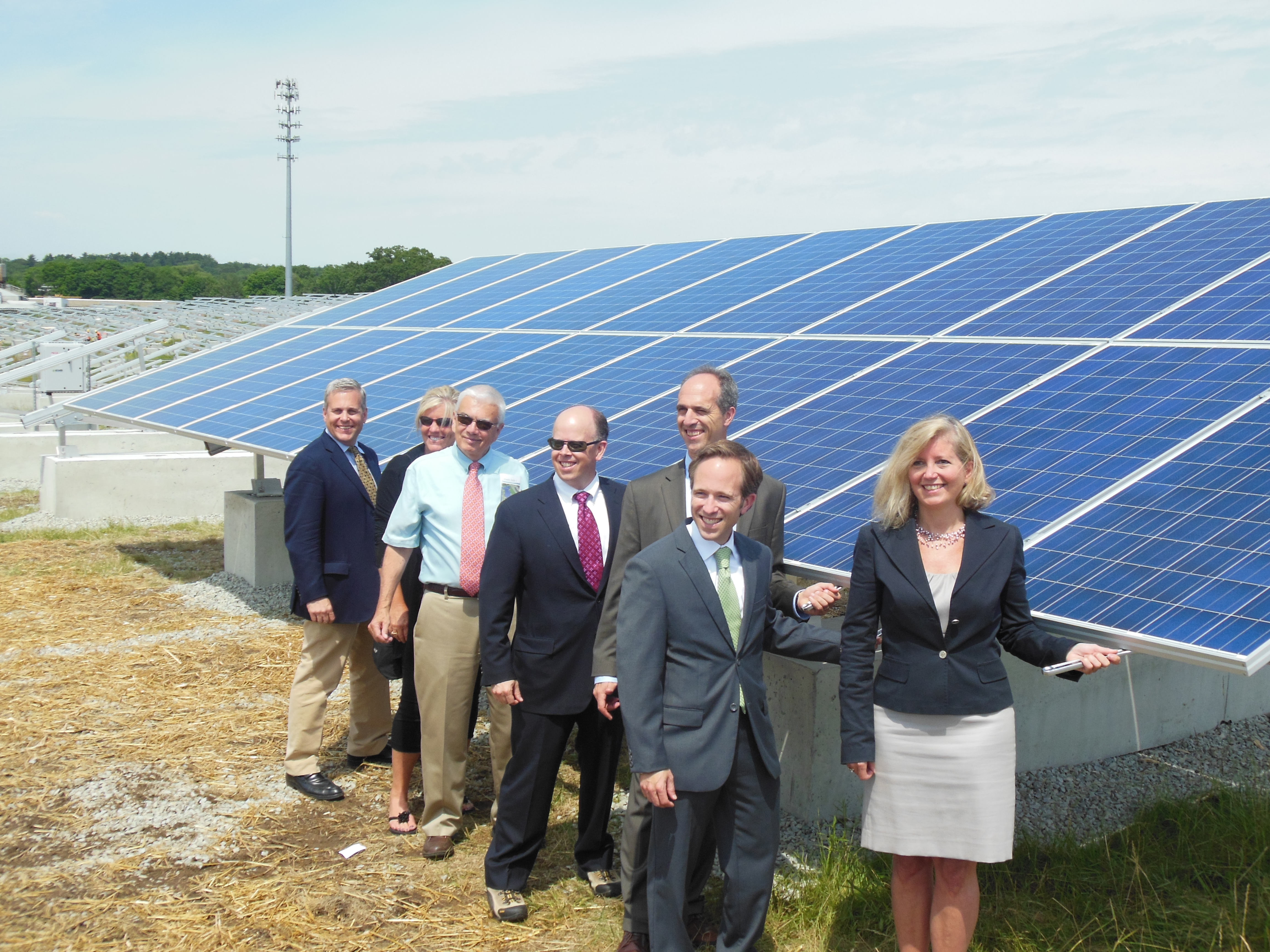 City officials pose outside Scituate, MA's 3 MW solar array that powers all city-owned facilities.