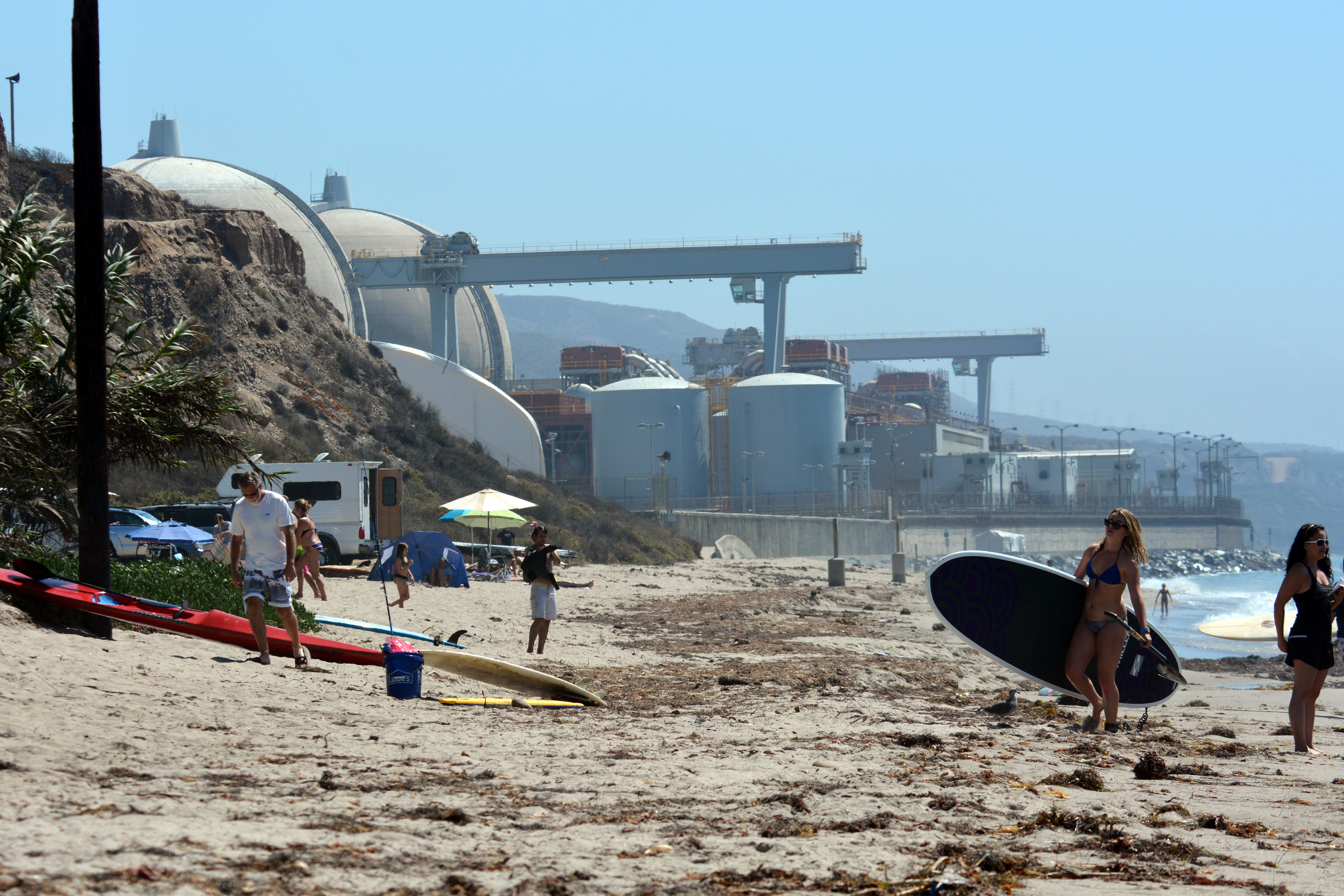 Surfers near the now-shuttered San Onofre reactors in southern California.